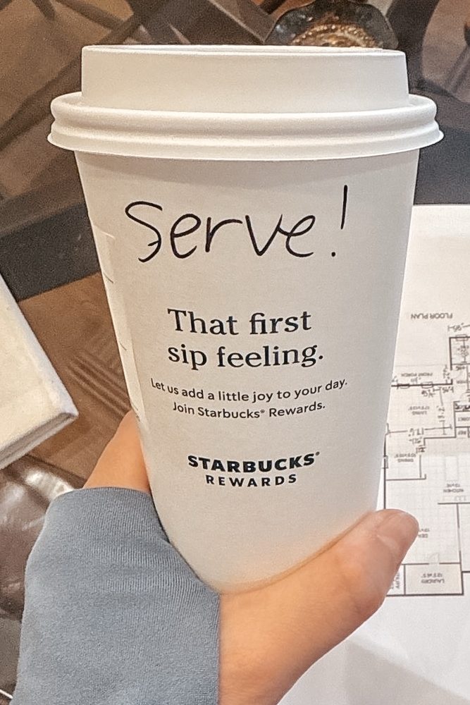 Starbucks cup with "Serve!" written on it.